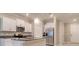 Bright modern kitchen featuring white cabinetry, granite countertops, and stainless steel appliances at 31718 Blue Passing Loop, Wesley Chapel, FL 33545