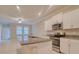 Modern kitchen with granite countertops, stainless steel appliances, and bright white cabinetry at 31718 Blue Passing Loop, Wesley Chapel, FL 33545