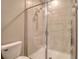 Tiled shower with a glass door and shower head at 31718 Blue Passing Loop, Wesley Chapel, FL 33545