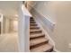 Staircase leading to the upper level with carpeted steps and white railing at 31718 Blue Passing Loop, Wesley Chapel, FL 33545