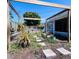 The backyard features a pergola garden and the home's blue exterior at 3309 Bayport Dr, Holiday, FL 34691