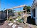 Landscaped backyard with a wooden pergola over the garden area, and pavers at 3309 Bayport Dr, Holiday, FL 34691