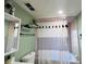Bathroom featuring modern vanity, framed mirror, and a stylish shower curtain at 3309 Bayport Dr, Holiday, FL 34691