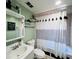 Cozy bathroom with modern vanity, framed mirror, and a stylish shower curtain at 3309 Bayport Dr, Holiday, FL 34691
