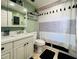 Cozy bathroom with modern vanity, framed mirror, and a stylish shower curtain at 3309 Bayport Dr, Holiday, FL 34691