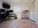 Bedroom with a large rug, closet, a desk with monitors and a collection of shoes in display cases at 3309 Bayport Dr, Holiday, FL 34691