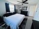 Bedroom with white bedding and a black dresser with a decorative mirror at 3309 Bayport Dr, Holiday, FL 34691