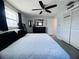 Bedroom with white bedding and a black dresser with a decorative mirror at 3309 Bayport Dr, Holiday, FL 34691