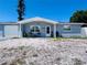 Charming single story home featuring a garage, blue paint and rock landscaping at 3309 Bayport Dr, Holiday, FL 34691