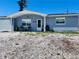 Charming single story home featuring a covered porch area and rock landscaping at 3309 Bayport Dr, Holiday, FL 34691