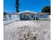 Charming single story home featuring a garage, blue paint and rock landscaping at 3309 Bayport Dr, Holiday, FL 34691