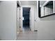 Hallway with neutral tile floors and view to an adjacent room at 3309 Bayport Dr, Holiday, FL 34691