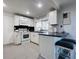 Bright kitchen features white cabinets, subway tile backsplash, breakfast bar, and tile flooring at 3309 Bayport Dr, Holiday, FL 34691