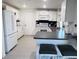 Bright kitchen features white cabinets, subway tile backsplash, and tile flooring at 3309 Bayport Dr, Holiday, FL 34691