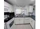 Bright kitchen features white cabinets, subway tile backsplash, breakfast bar, and tile flooring at 3309 Bayport Dr, Holiday, FL 34691