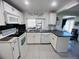 Bright kitchen features white cabinets, subway tile backsplash, and tile flooring at 3309 Bayport Dr, Holiday, FL 34691