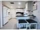 Bright, efficient kitchen with white cabinets, stainless appliances, sleek countertops, and modern breakfast bar seating at 3309 Bayport Dr, Holiday, FL 34691