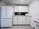 Bright kitchen features white cabinets, subway tile backsplash, and tile flooring at 3309 Bayport Dr, Holiday, FL 34691