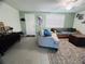 Cozy living room featuring tile floors, plentiful light and comfortable seating, perfect for relaxing and entertaining guests at 3309 Bayport Dr, Holiday, FL 34691