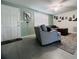 Bright and cozy living room area with comfortable seating, tile floor and stylish decor, creating an inviting space to unwind at 3309 Bayport Dr, Holiday, FL 34691