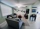 The open-concept living room features a cozy seating area, TV, and bright natural light at 3309 Bayport Dr, Holiday, FL 34691