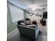 The open-concept living room features a cozy seating area, TV, and bright natural light at 3309 Bayport Dr, Holiday, FL 34691