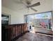 Enclosed porch featuring a ceiling fan, tile floor, outdoor bar and view of shed in backyard at 3309 Bayport Dr, Holiday, FL 34691