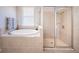 Bright bathroom featuring a soaking tub and a glass-enclosed shower stall at 3515 Albritton St, New Port Richey, FL 34655