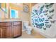 Well-maintained bathroom featuring a butterfly shower curtain and modern vanity at 3515 Albritton St, New Port Richey, FL 34655