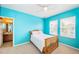 Bright bedroom with light blue walls, wood frame bed, and a view of the outdoors at 3515 Albritton St, New Port Richey, FL 34655