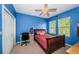 Cozy bedroom with red plaid bedding, a desk, and a comfortable study area at 3515 Albritton St, New Port Richey, FL 34655