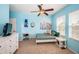 Comfortable bedroom with soft blue walls, decorative wall art, and bright natural light at 3515 Albritton St, New Port Richey, FL 34655