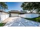 Home's exterior featuring a two-car garage and an expansive paved driveway at 3515 Albritton St, New Port Richey, FL 34655