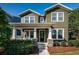 Charming two-story home featuring a covered porch with stone accents and manicured landscaping at 3515 Albritton St, New Port Richey, FL 34655