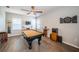 Spacious game room featuring a pool table, television, and sleek wood flooring at 3515 Albritton St, New Port Richey, FL 34655