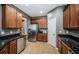 Well-organized kitchen features granite countertops, stainless steel appliances, and wooden cabinetry at 3515 Albritton St, New Port Richey, FL 34655