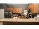 Spacious kitchen featuring stainless steel appliances, granite countertops, and ample cabinet space at 3593 Gerrads Cross Ct, Land O Lakes, FL 34638