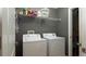The laundry room features essential appliances for efficient garment care at 3593 Gerrads Cross Ct, Land O Lakes, FL 34638