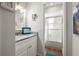 Bathroom with white vanity, granite countertop, and a tub/shower combo featuring decorative glass doors at 4140 Passport Ln # 204, New Port Richey, FL 34653