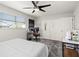 Bedroom featuring a ceiling fan, workspace, and double closet doors for ample storage at 4140 Passport Ln # 204, New Port Richey, FL 34653