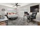 Comfortable bedroom with a ceiling fan, a workspace, and a gray rug at 4140 Passport Ln # 204, New Port Richey, FL 34653
