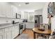 Bright kitchen featuring white cabinets, stainless steel appliances, and a cozy breakfast nook at 4140 Passport Ln # 204, New Port Richey, FL 34653