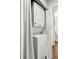 Compact laundry area with stacked washer and dryer, discreetly concealed by curtains at 4140 Passport Ln # 204, New Port Richey, FL 34653