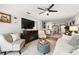 Living room features large tv and comfy seating in an open floor plan at 4140 Passport Ln # 204, New Port Richey, FL 34653