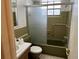Bathroom featuring a toilet, sink, and a glass-enclosed tub/shower combination at 4223 Sheldon Pl # H, New Port Richey, FL 34652