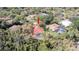 Aerial view of a home with a pool surrounded by lush greenery and mature trees in a quiet neighborhood at 4475 Rachel Blvd, Spring Hill, FL 34607