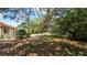 Expansive backyard with mature trees and a screened-in pool enclosure provides privacy and shade at 4475 Rachel Blvd, Spring Hill, FL 34607