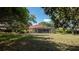 View of the screened pool from the grassy backyard at 4475 Rachel Blvd, Spring Hill, FL 34607