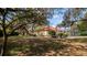 Spacious backyard with mature shade trees surrounding the home at 4475 Rachel Blvd, Spring Hill, FL 34607