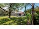 Large backyard with screened-in pool area and mature trees at 4475 Rachel Blvd, Spring Hill, FL 34607